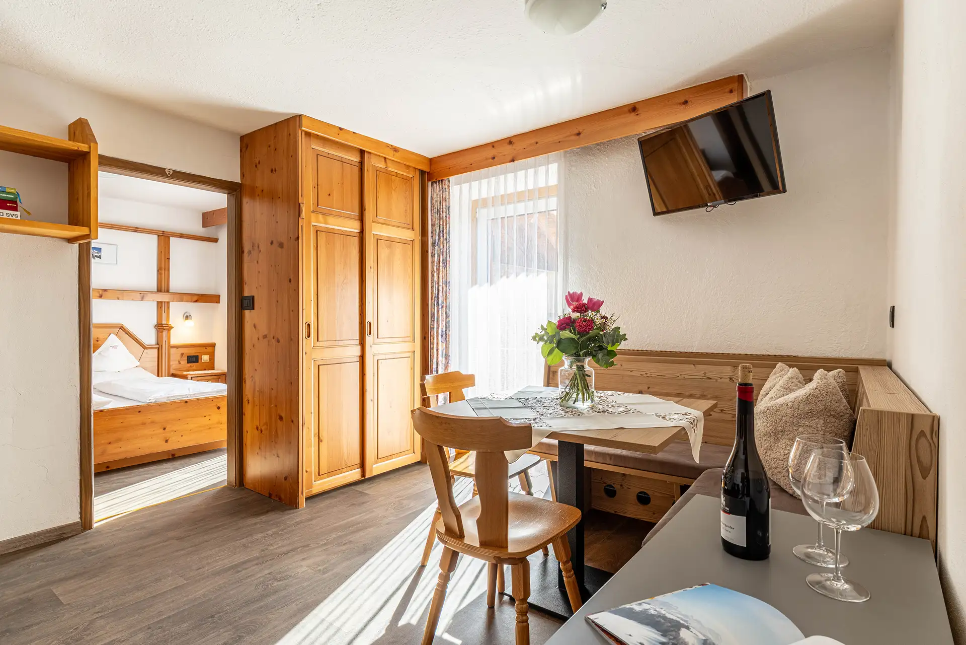 Heller Wohnbereich im Apartment Rododendro mit Blick auf die Dolomiten im Farmhouse Plang.